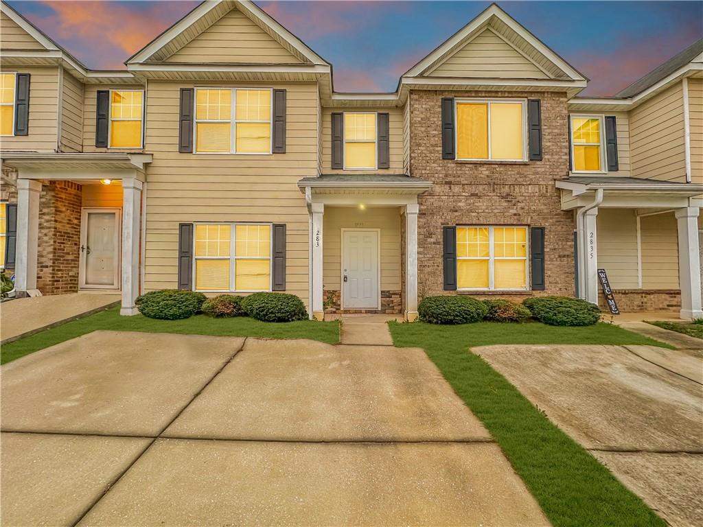 a front view of a house with yard