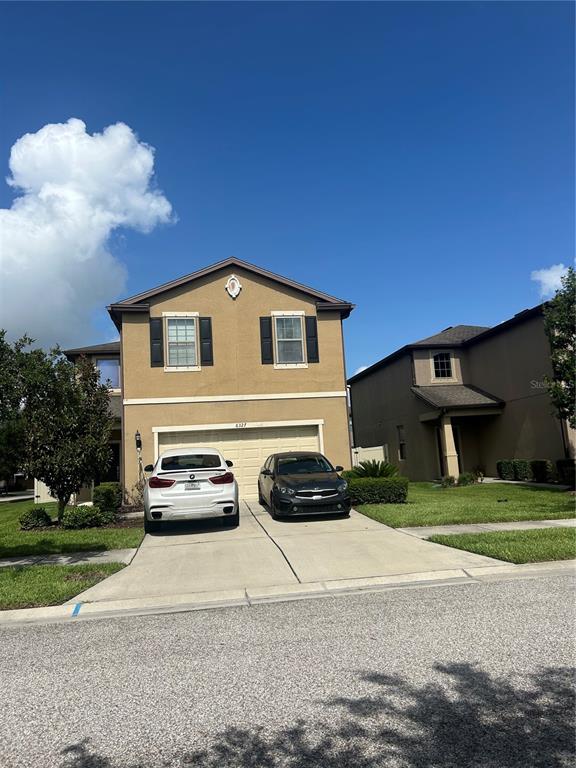 a front view of a house with a yard