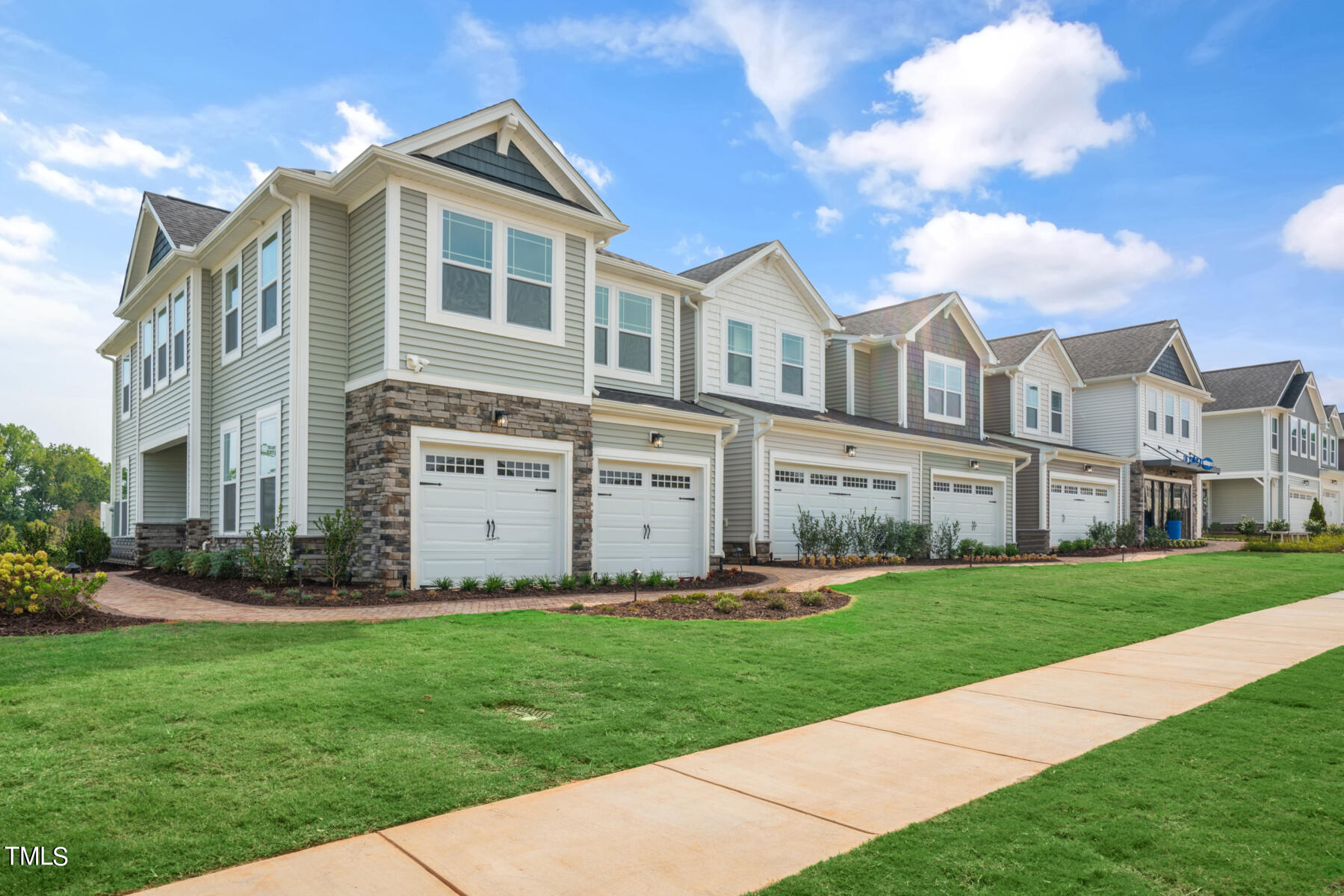 a front view of a house with a garden and yard