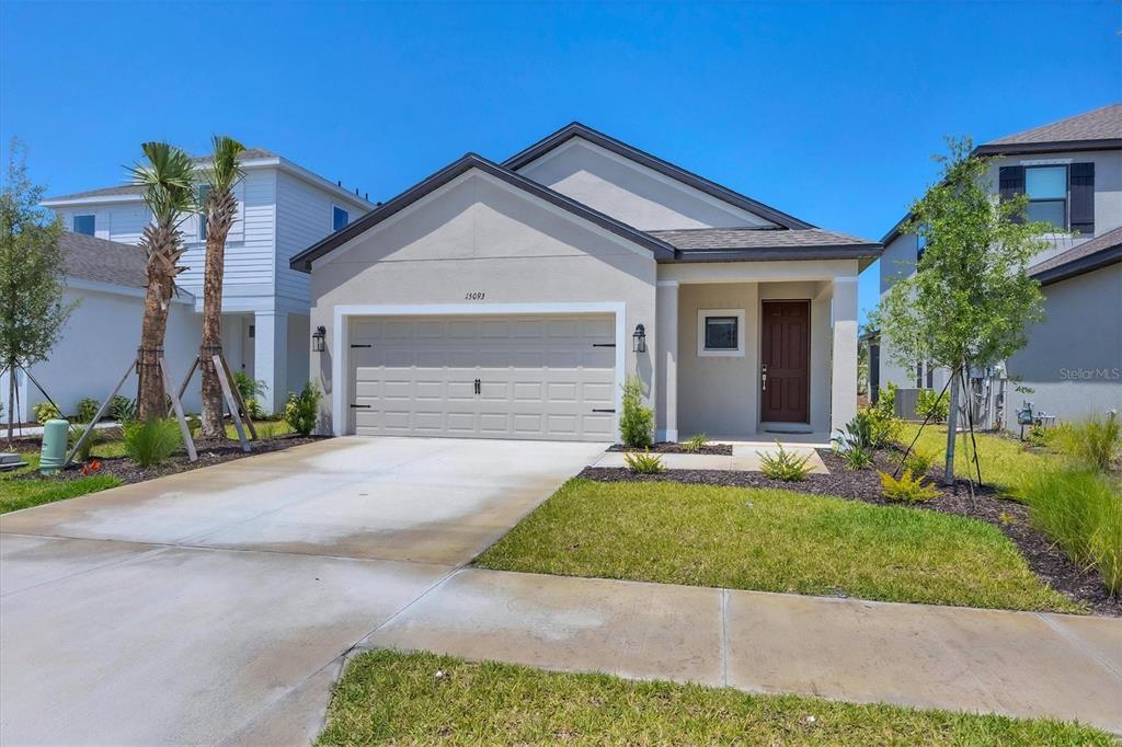 a front view of a house with a yard and garage