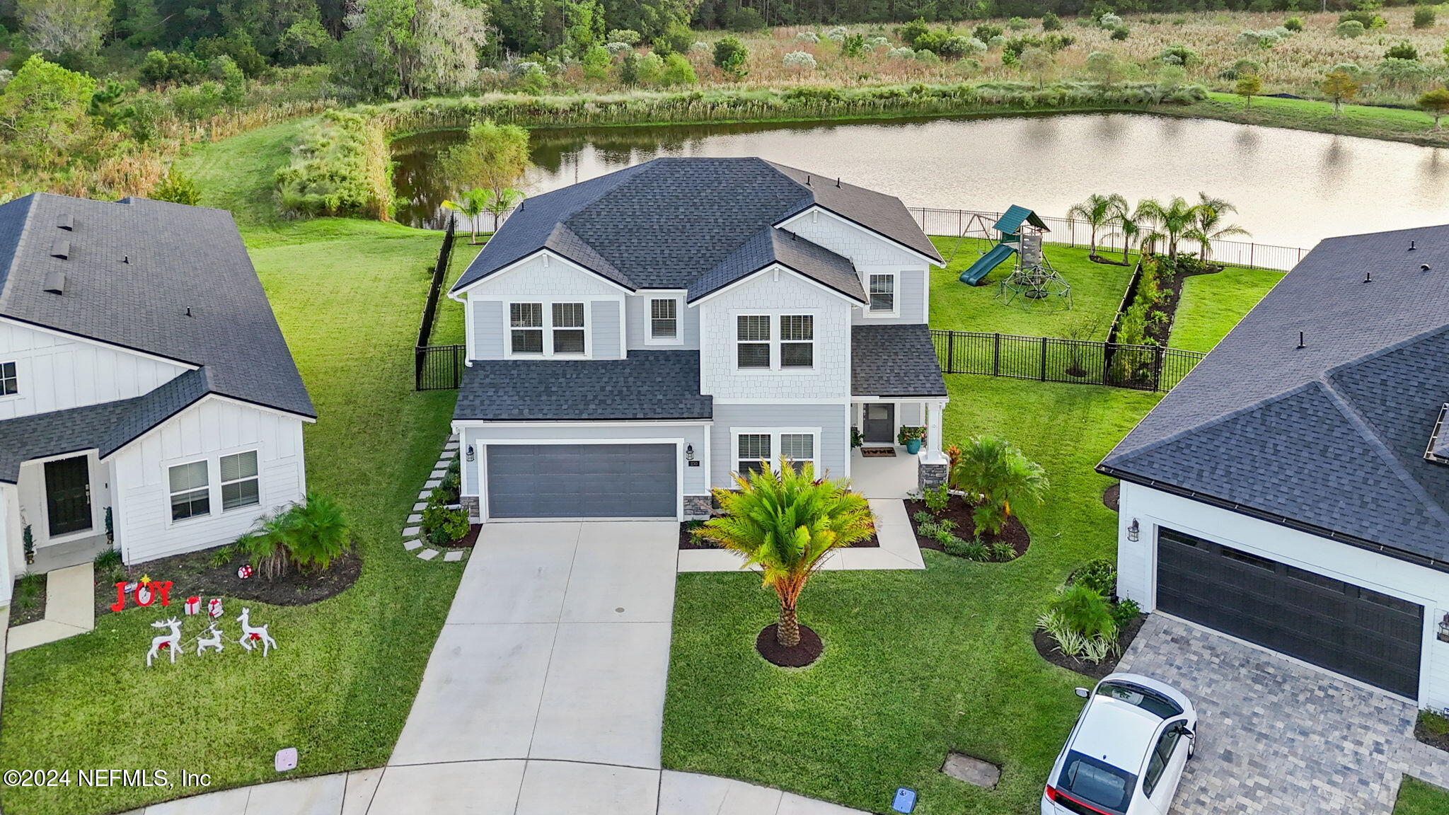 an aerial view of a house with garden space and a yard