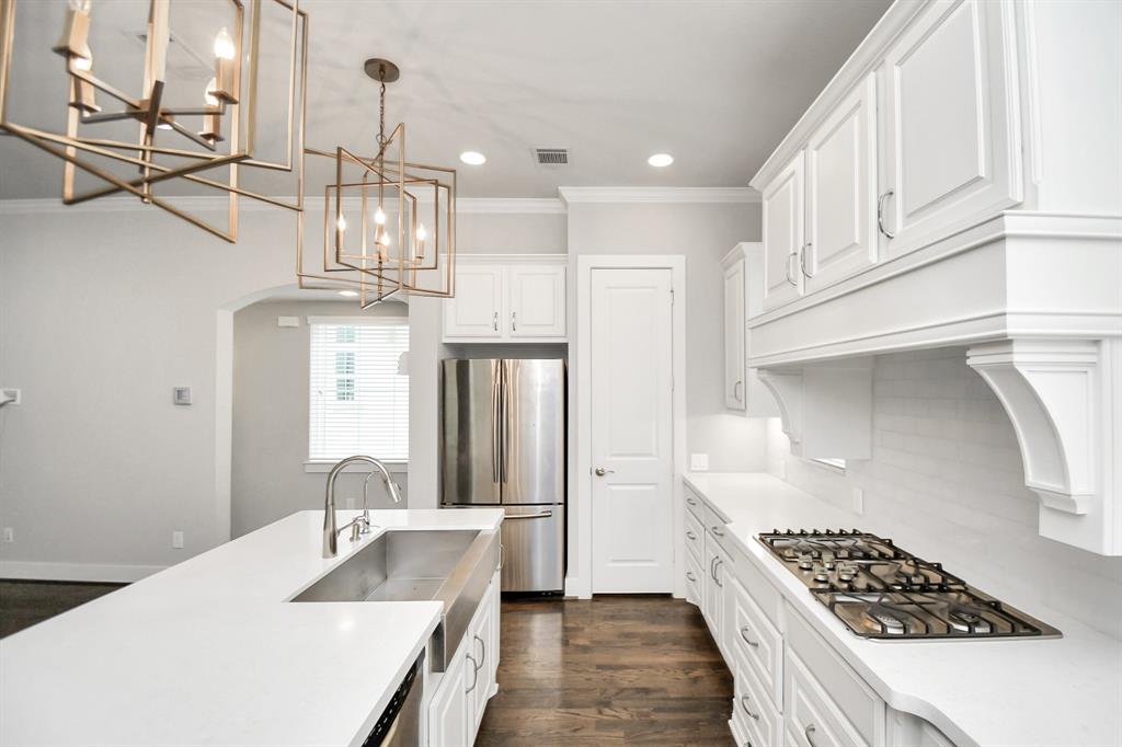 a kitchen with granite countertop a sink stainless steel appliances and cabinets