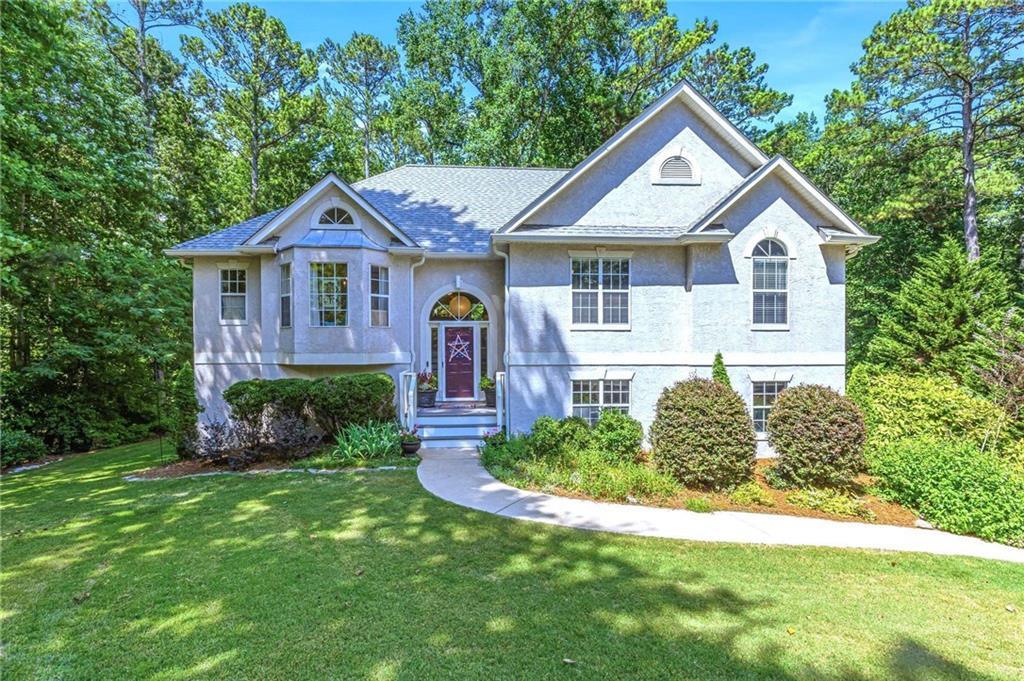 a front view of a house with a yard