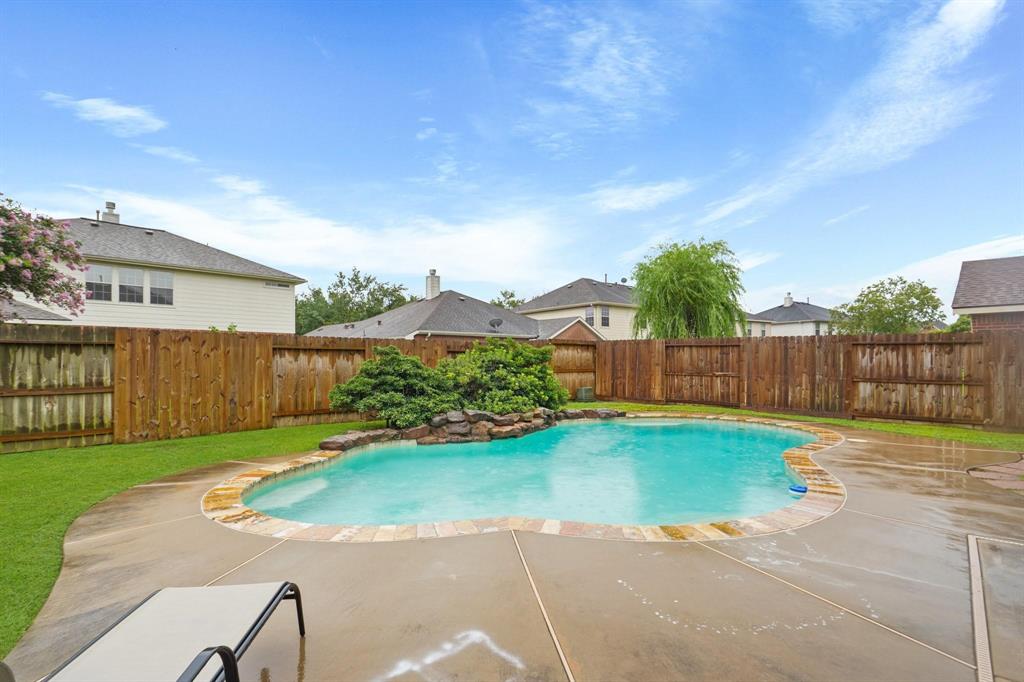 a view of a backyard with wooden fence