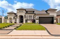 View of front of home featuring a garage and a front yard