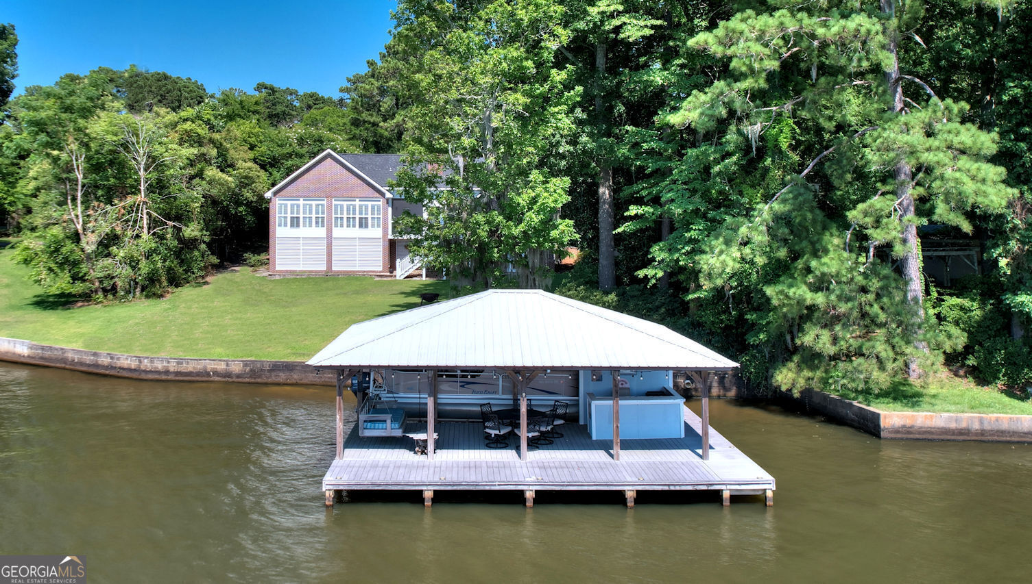 a view of a house with a yard from a lake view