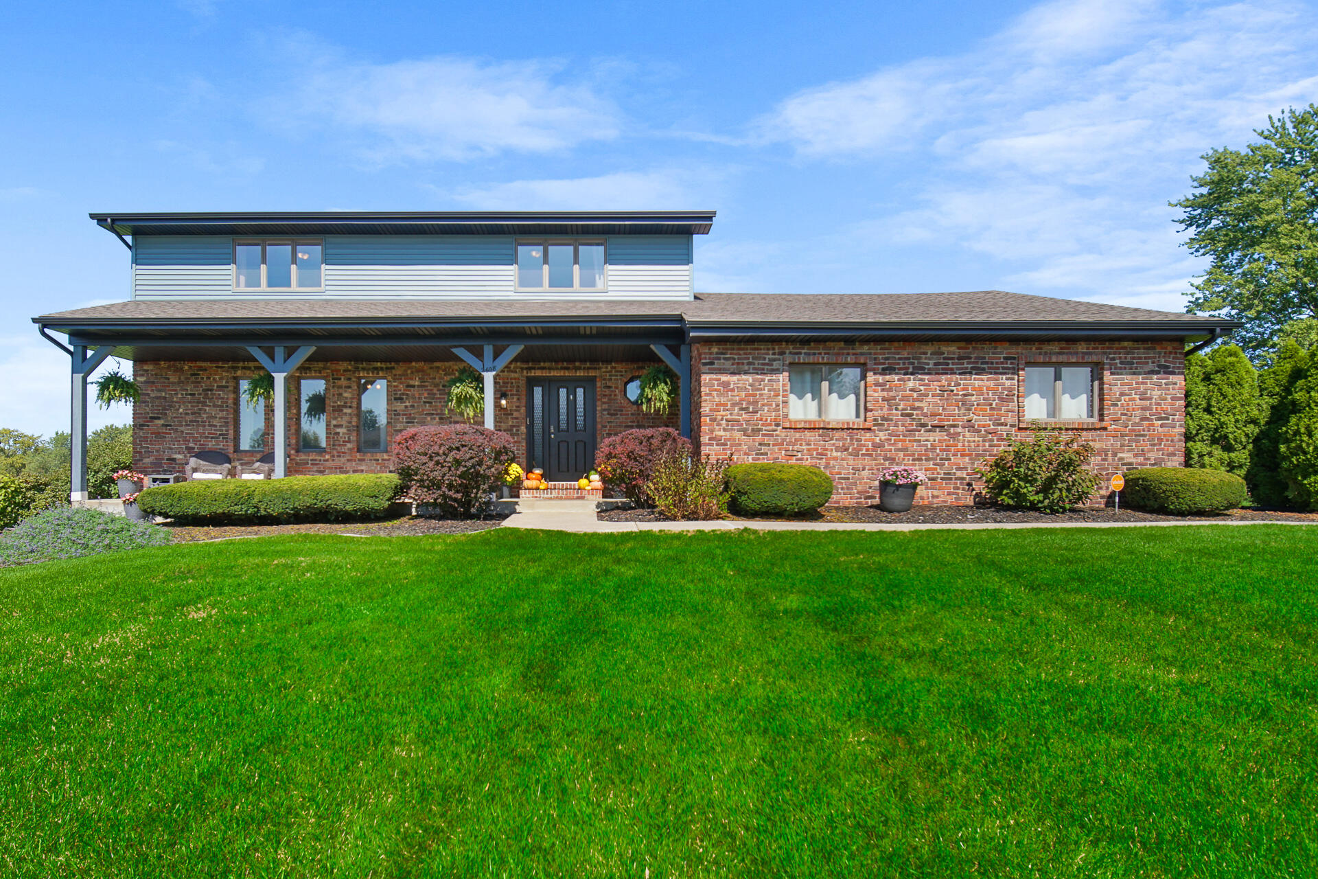 a front view of a house with garden