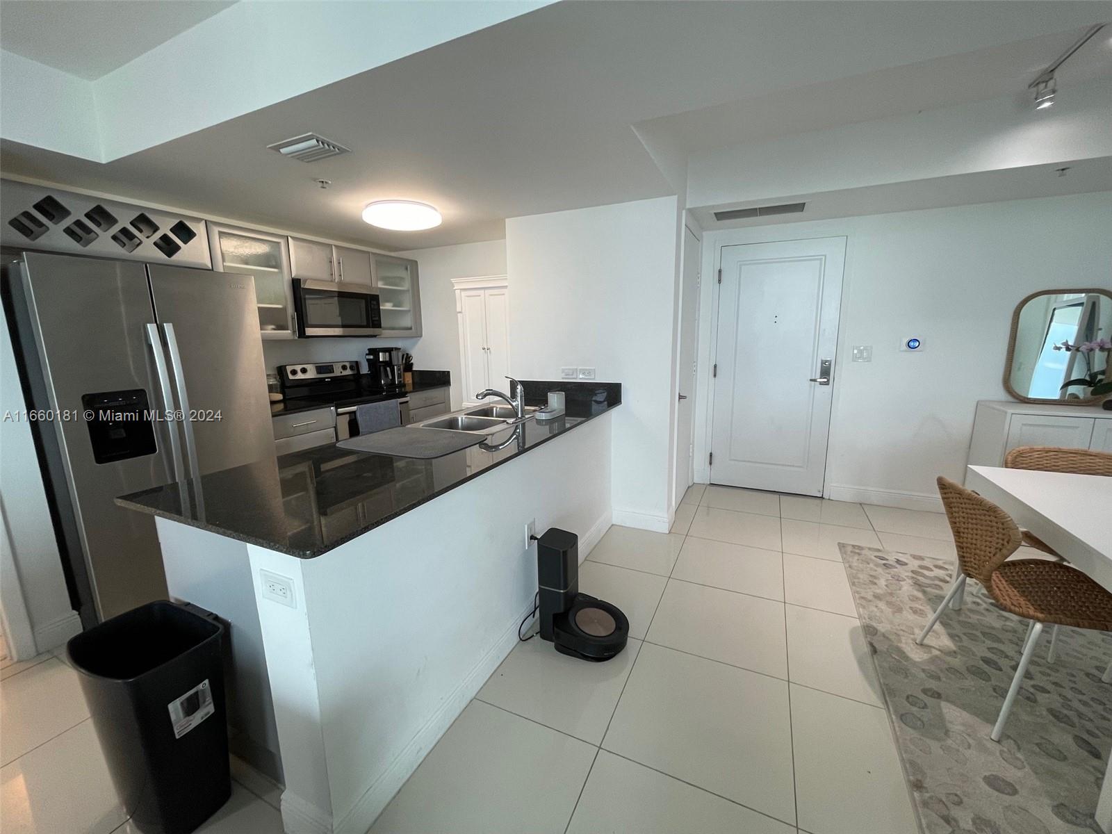 a kitchen with stainless steel appliances a sink a stove and a refrigerator