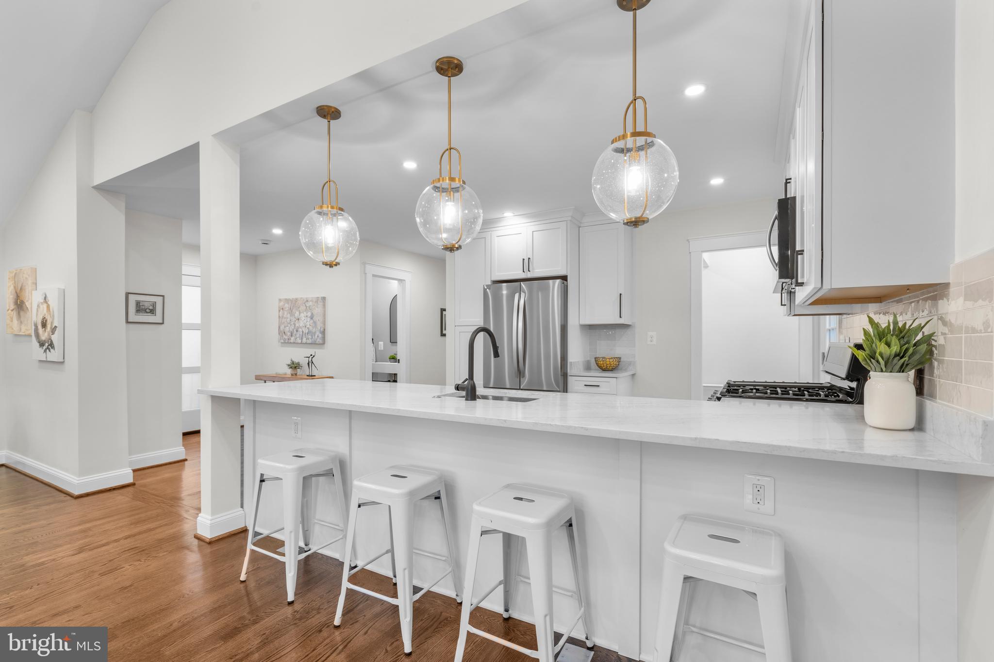 a kitchen with a dining table a sink and cabinets