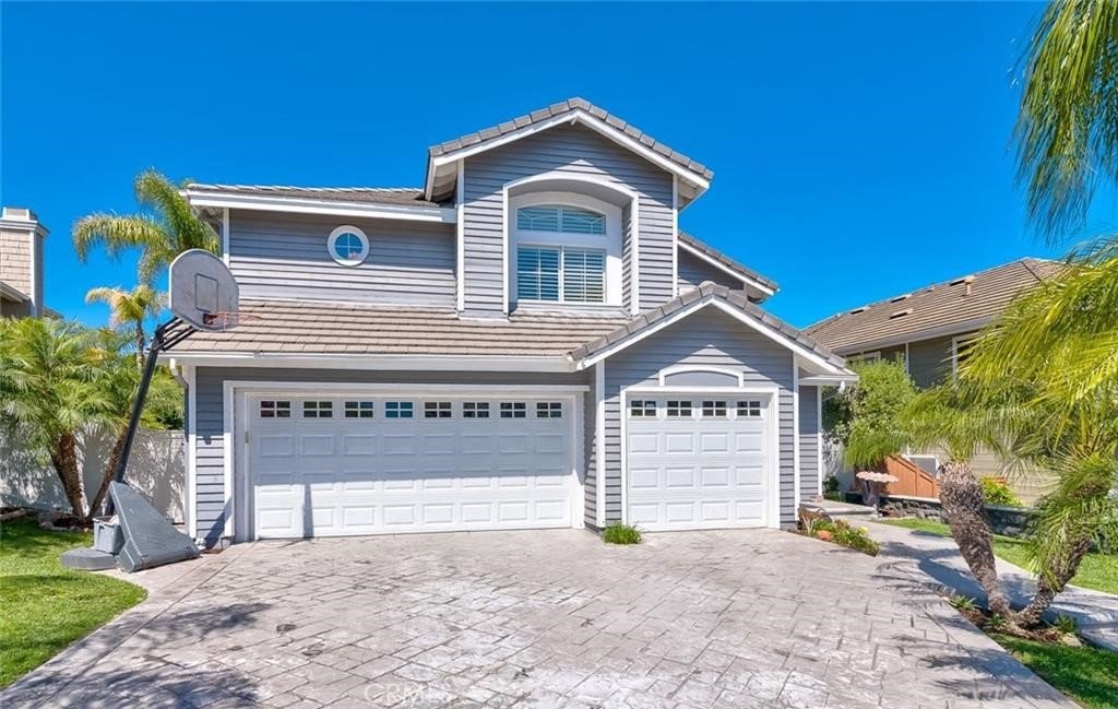 a front view of a house with a yard and garage