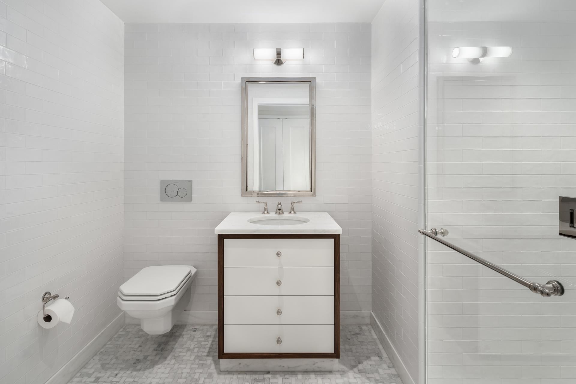 a bathroom with a toilet a sink and a mirror