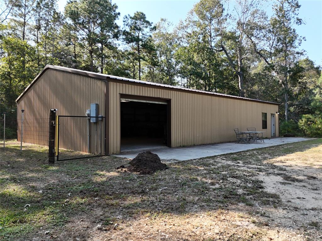 a view of a barn in the middle of a yard