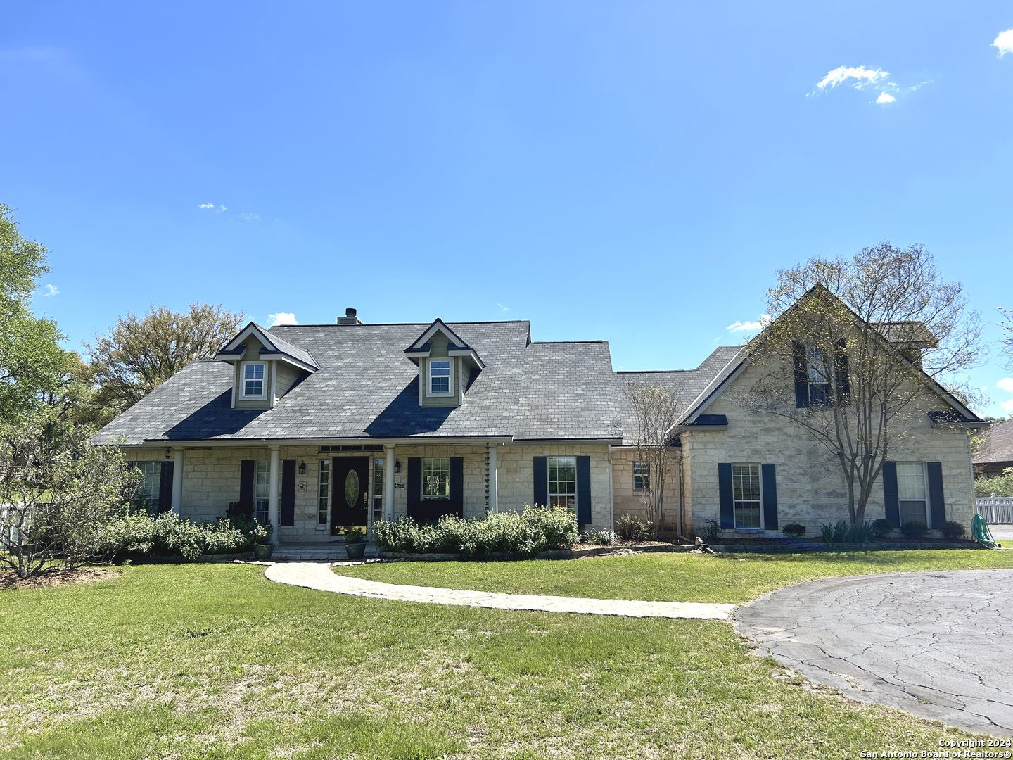 a front view of a house with a garden and porch