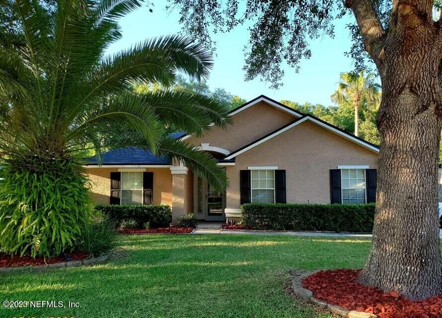 a front view of house with yard and green space