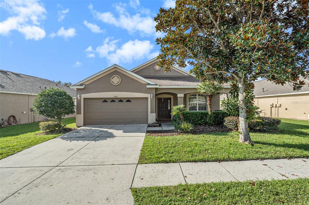 a front view of a house with a yard and garage