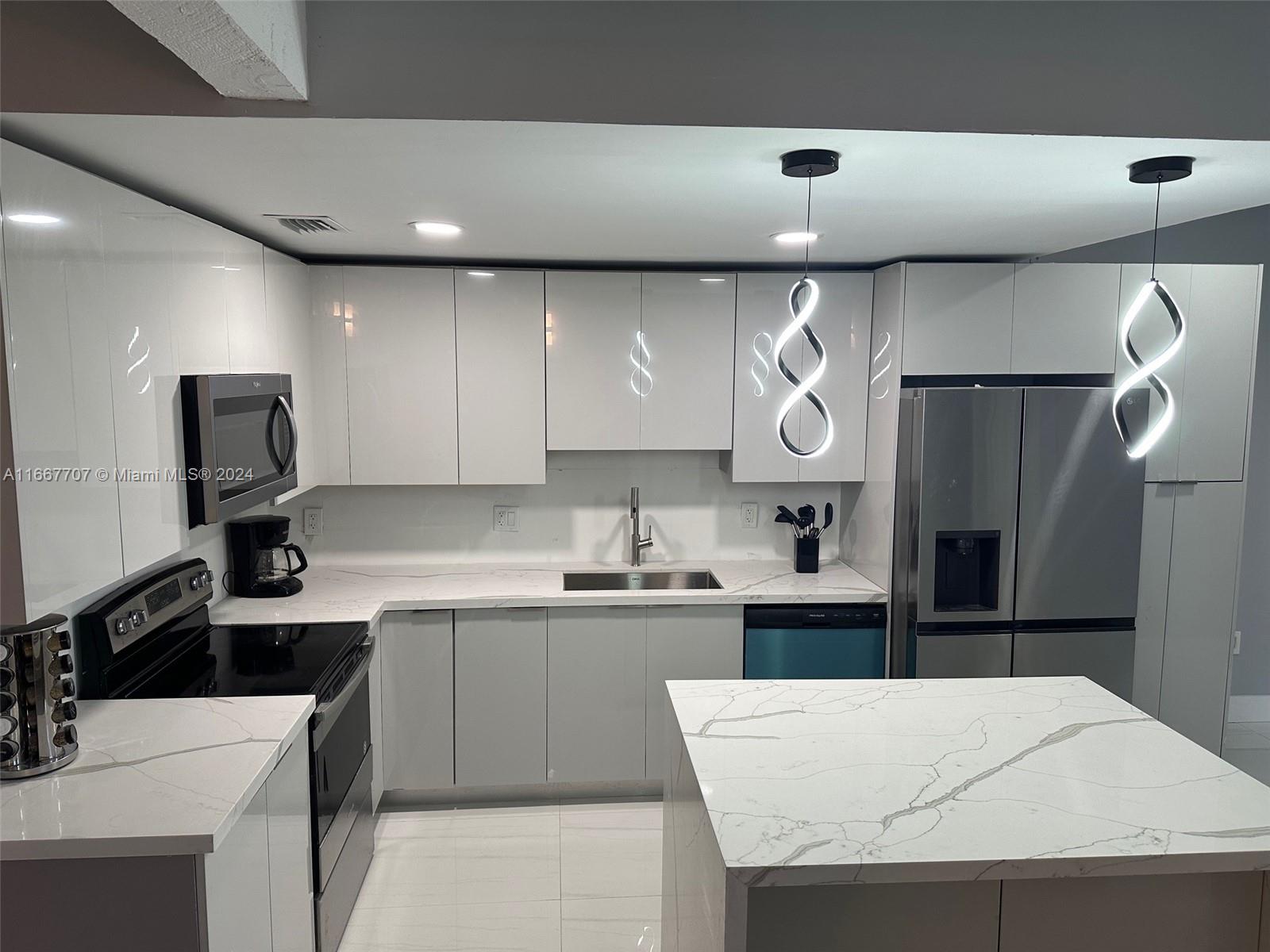 a kitchen with a sink a stove a refrigerator and cabinets