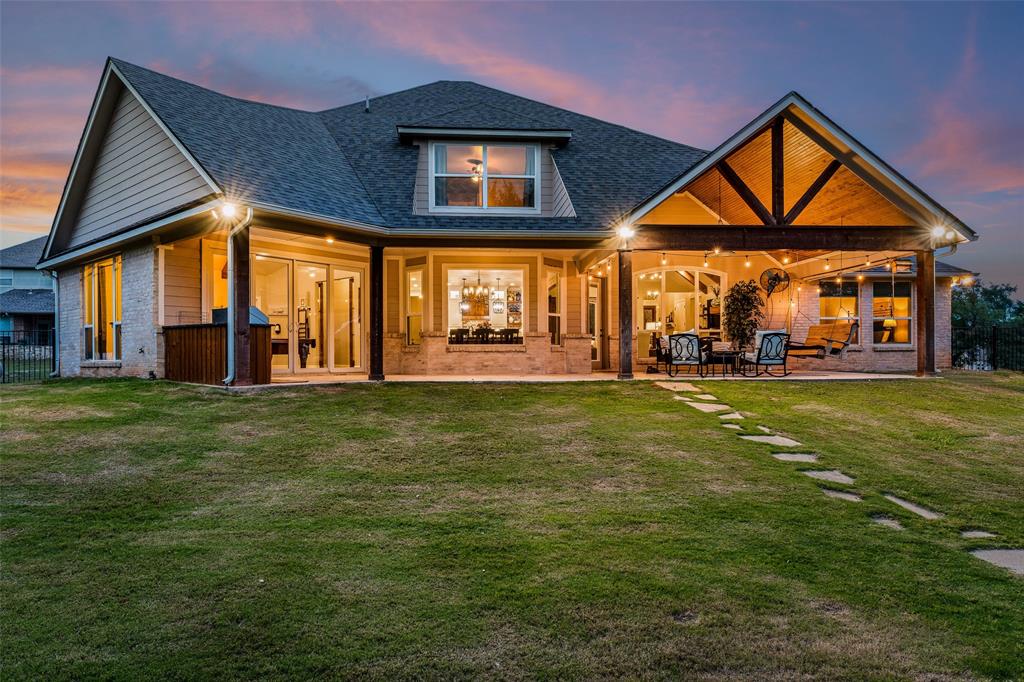 a front view of house with outdoor seating and yard