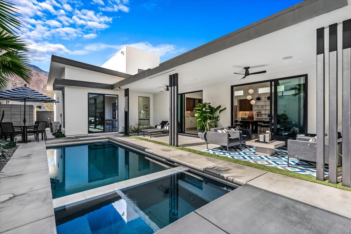 a view of a patio with swimming pool table and chairs