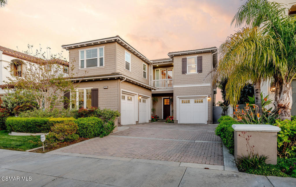 a front view of a house with a yard and a garage