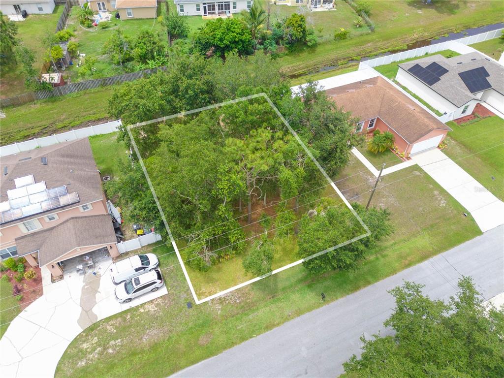 an aerial view of a residential houses with outdoor space and street view