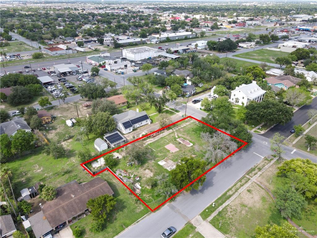 an aerial view of residential houses with outdoor space and trees