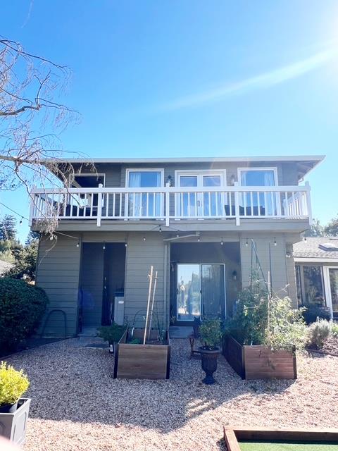 a front view of a house with porch and plants