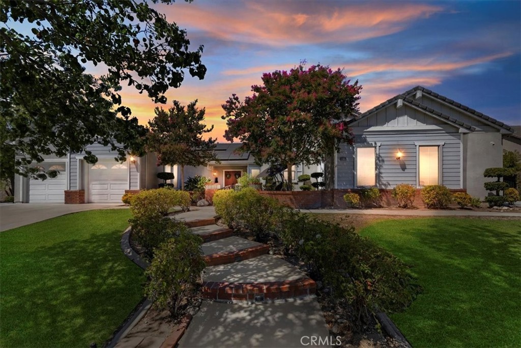 a front view of a house with garden