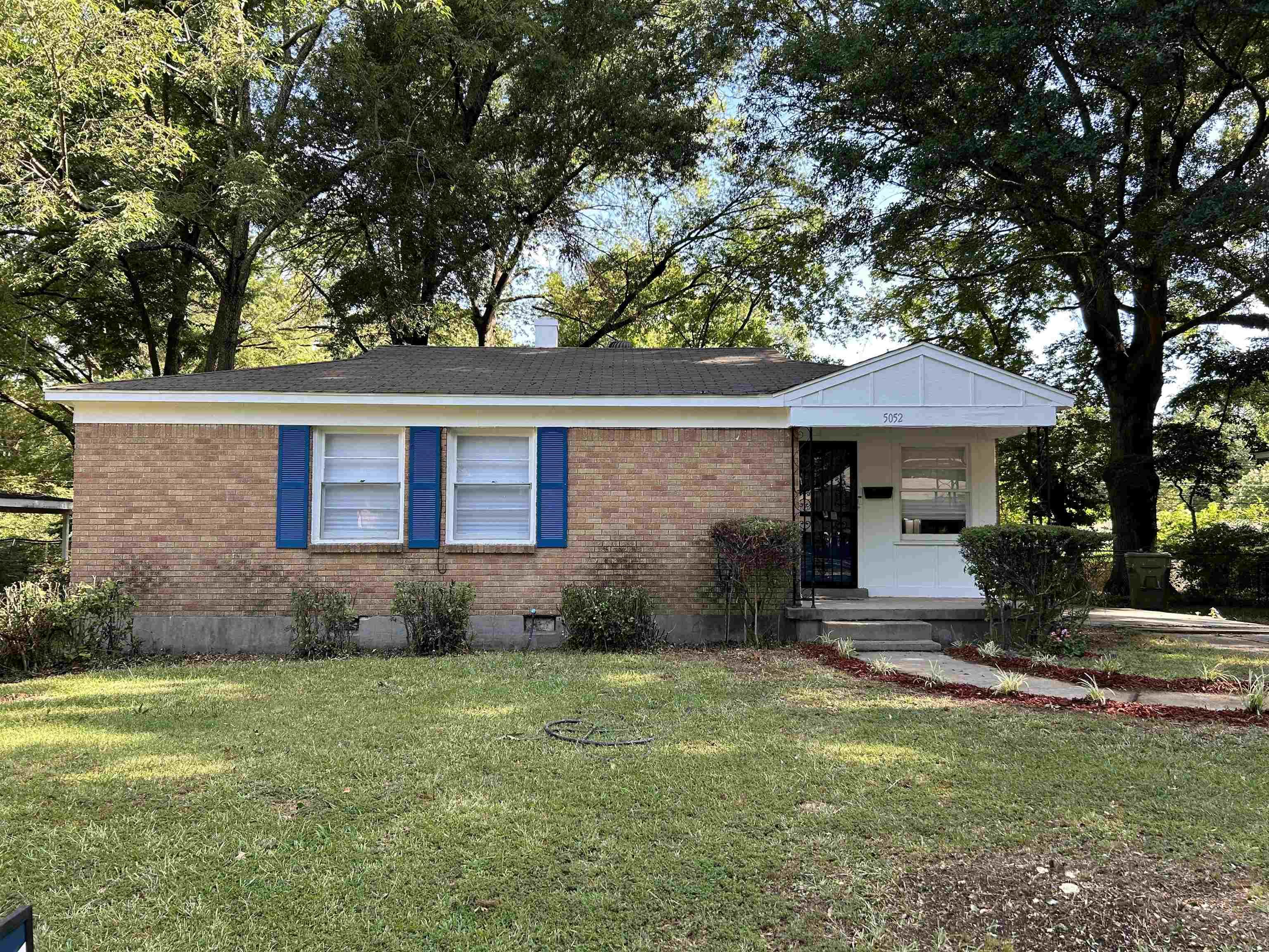 Ranch-style home with a front lawn