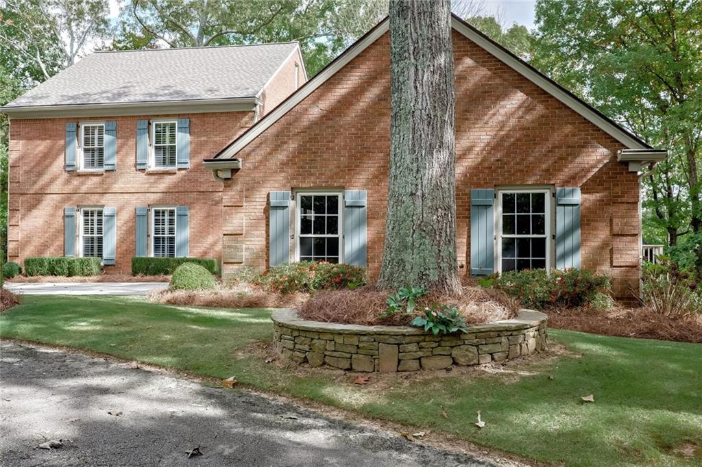 a front view of a house with garden and porch