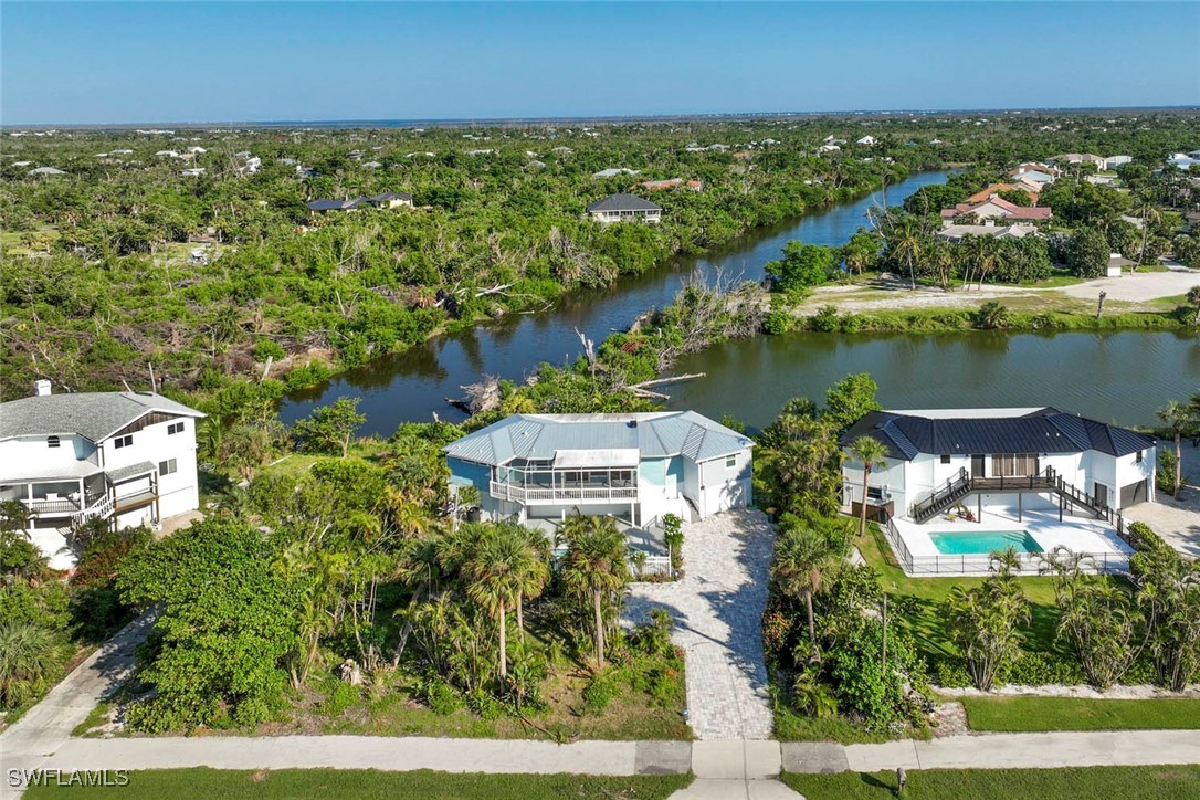 an aerial view of residential houses with outdoor space and lake view