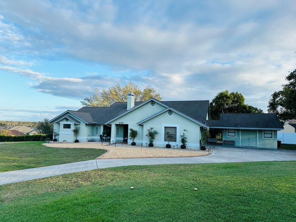 a front view of house with yard and green space