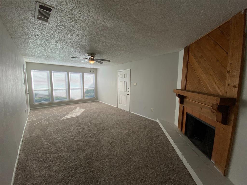 a view of empty room with a fireplace