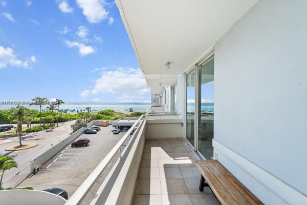 a view of a balcony with wooden floor