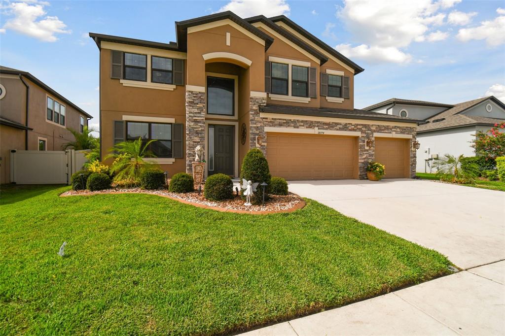 a front view of a house with a yard and garage