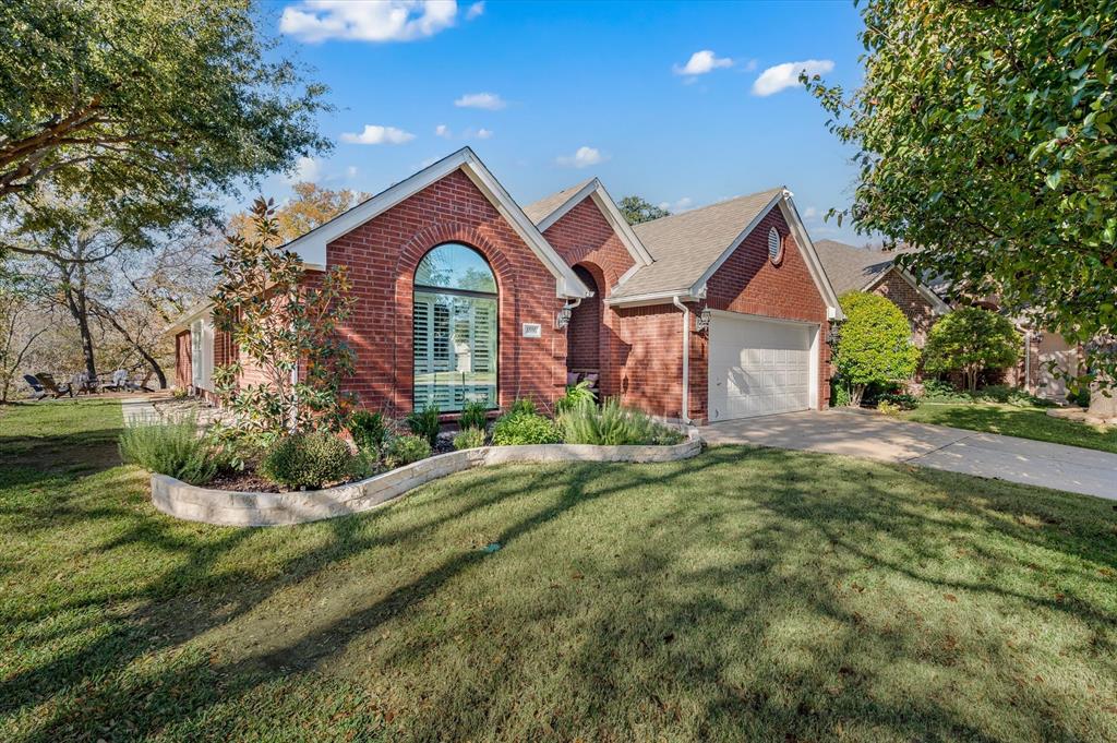 a front view of a house with yard and green space