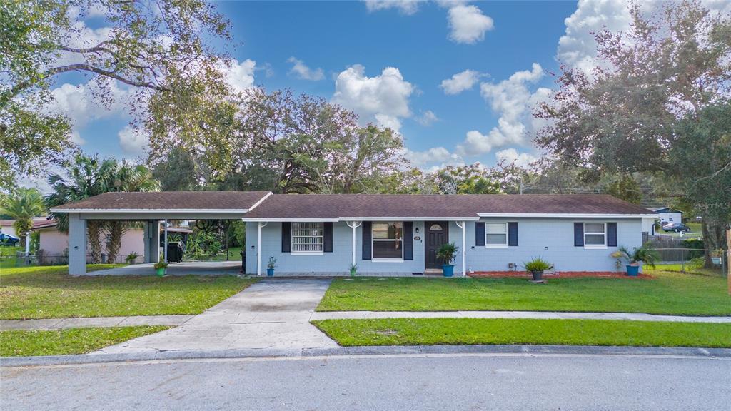 a front view of house with yard and green space