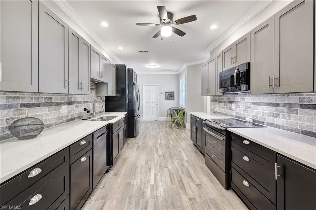 a large kitchen with stainless steel appliances granite countertop a sink stove and cabinets