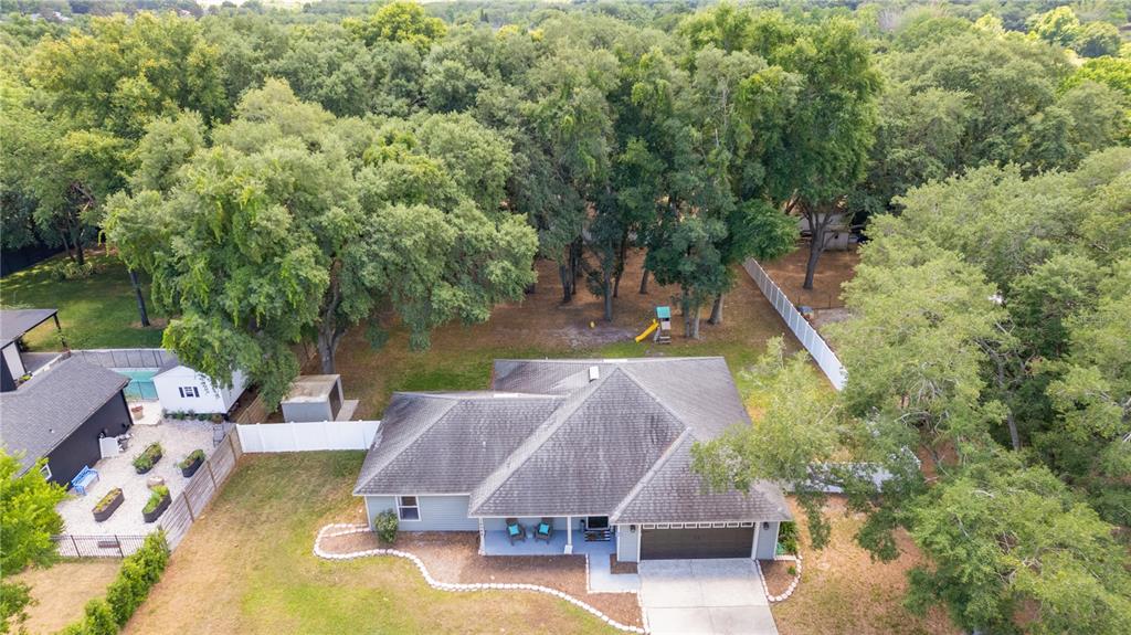 an aerial view of a house with swimming pool garden and patio