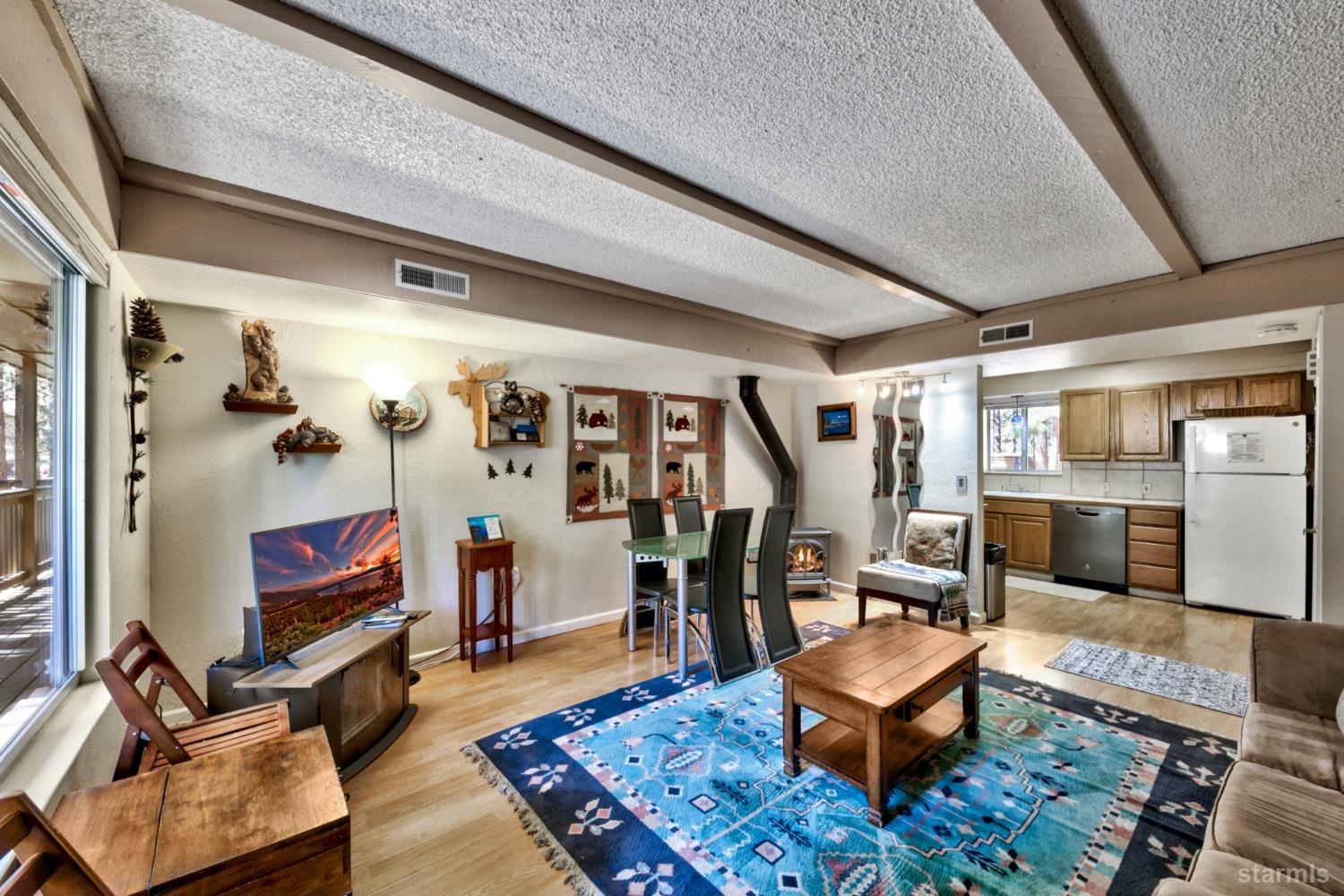 a living room with furniture rug and wooden floor