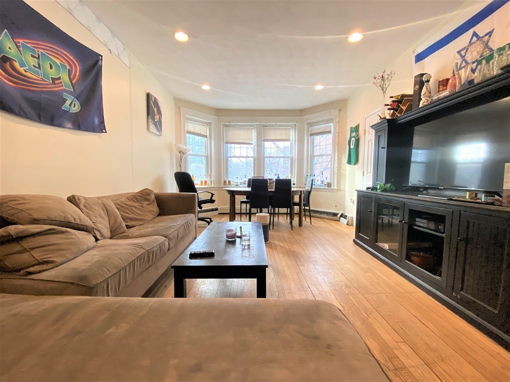 a living room with furniture flat screen tv and a fireplace