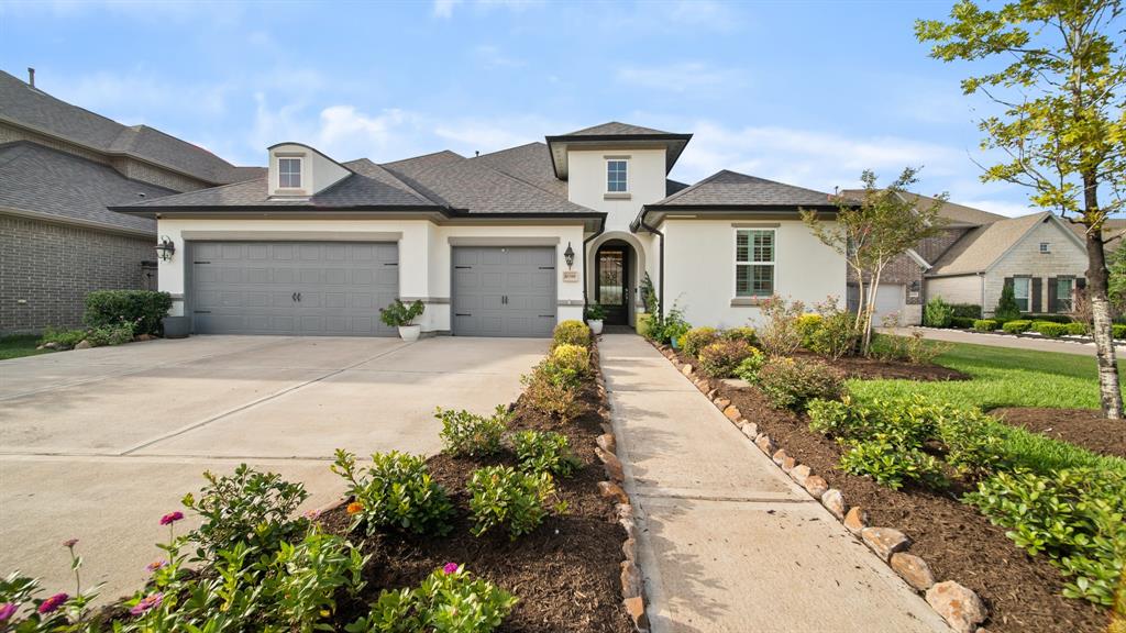 a front view of a house with a yard and outdoor seating