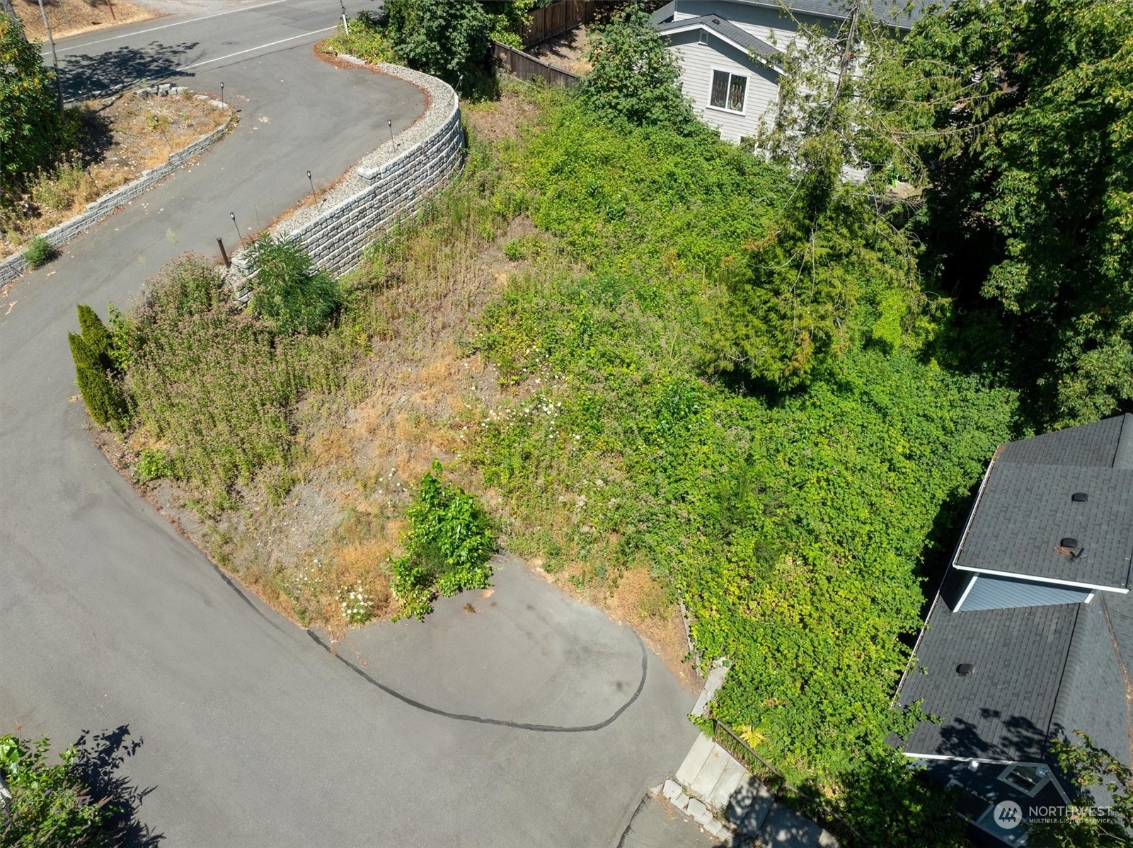 an aerial view of a house with a yard and trees