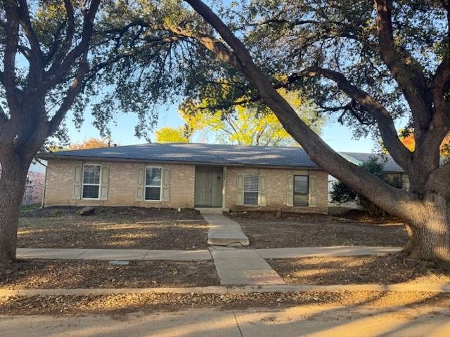 a view of a house with a tree in front of it