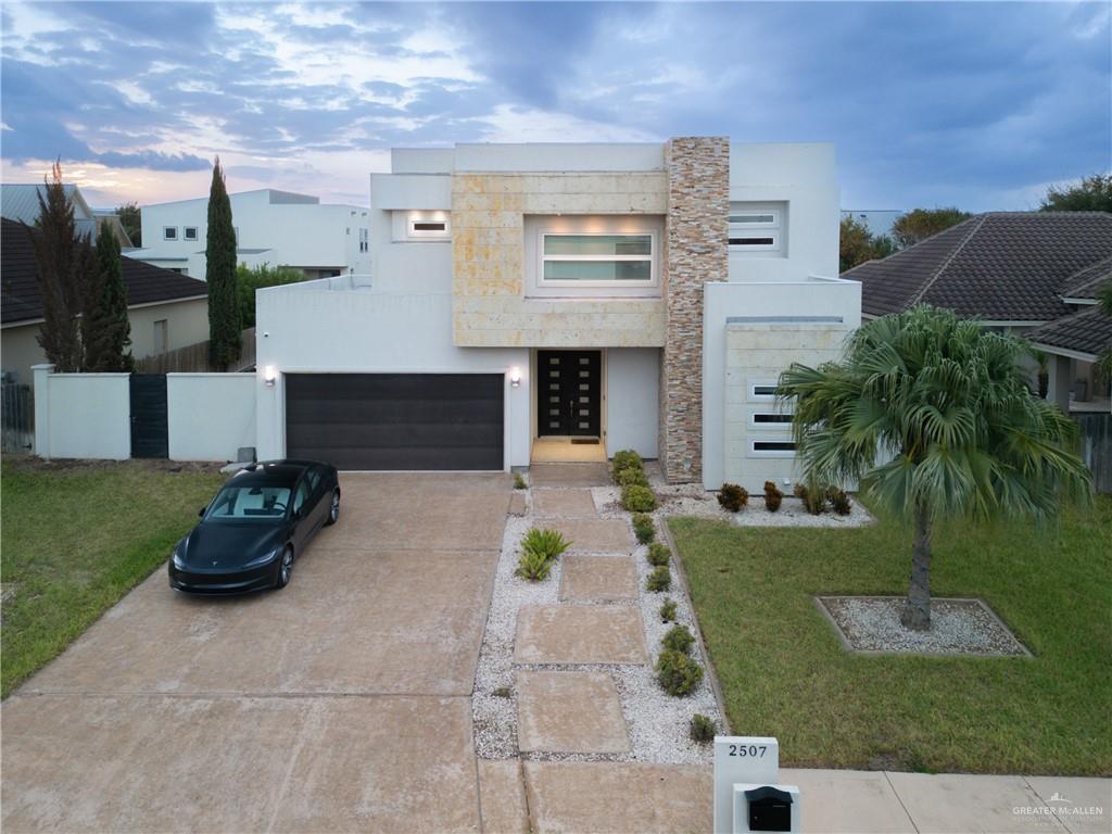 a front view of a house with a garden and seating area