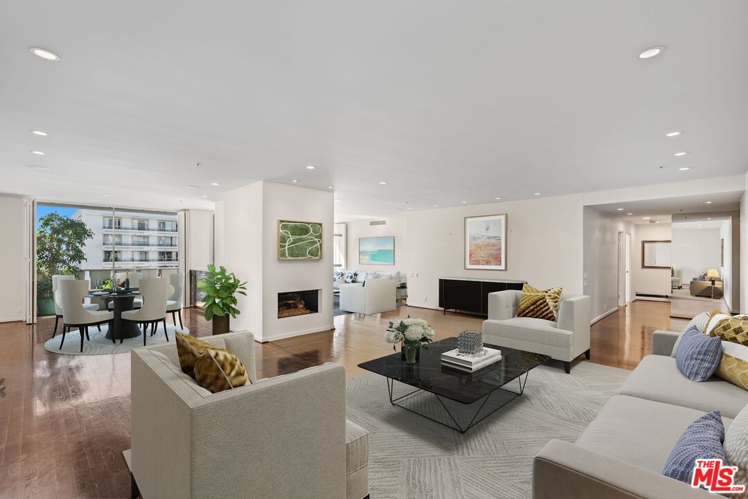 a living room with furniture large window and a table