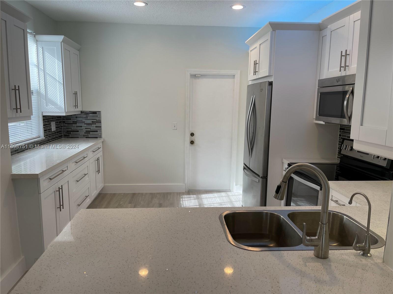 a kitchen with a sink a refrigerator and a sink