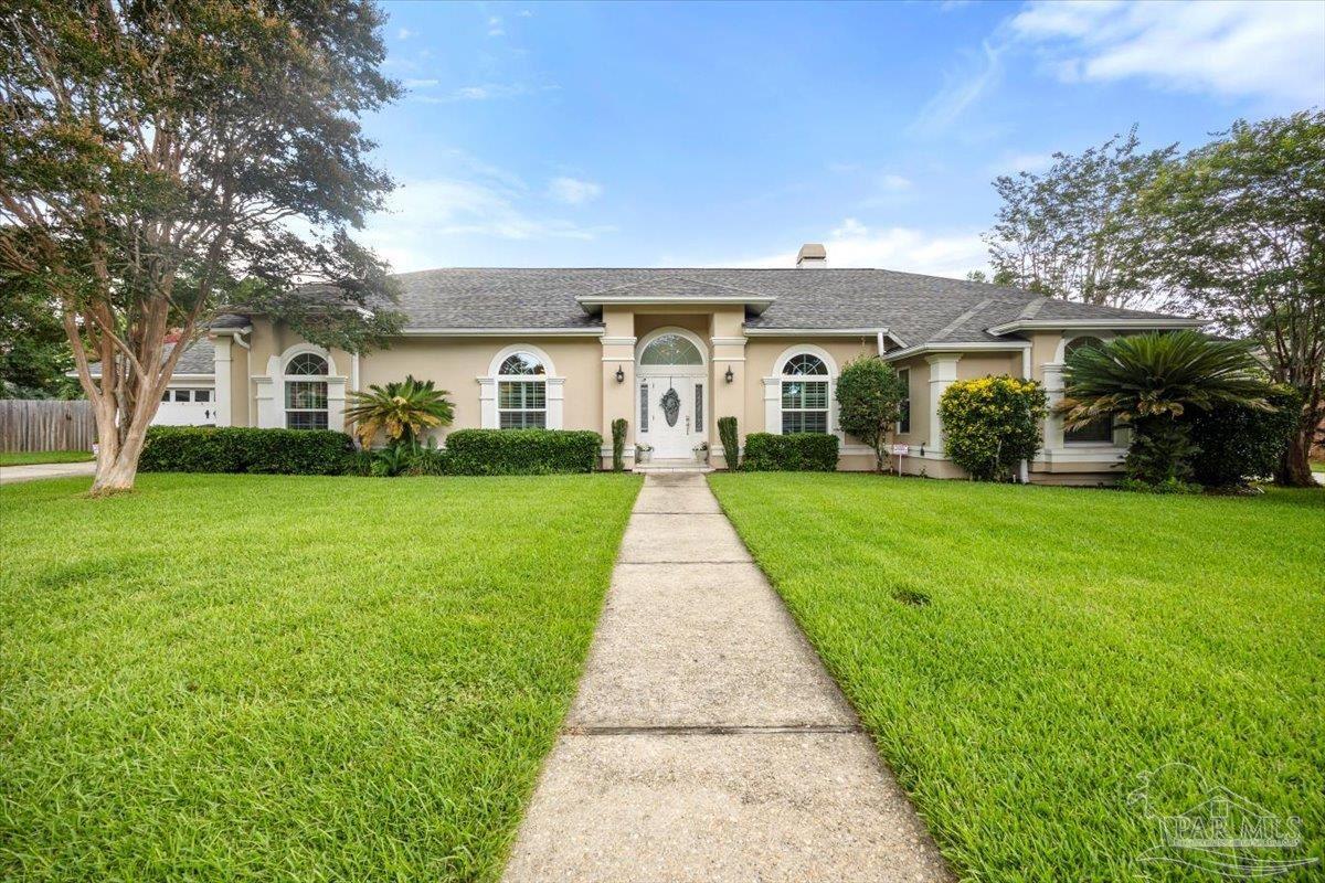 a front view of house with yard and green space