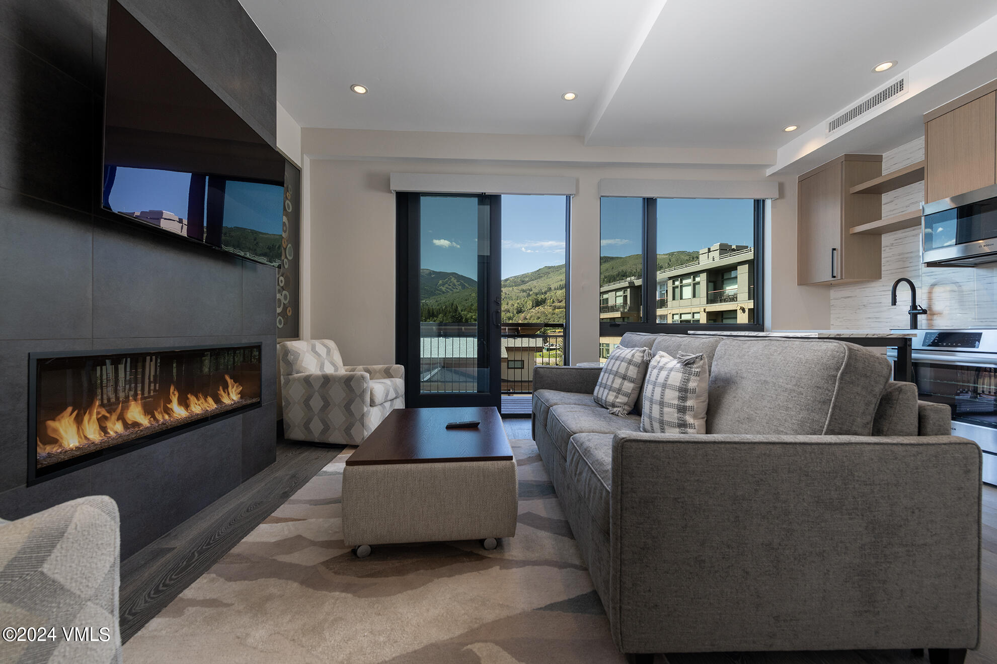 a living room with furniture and a fireplace