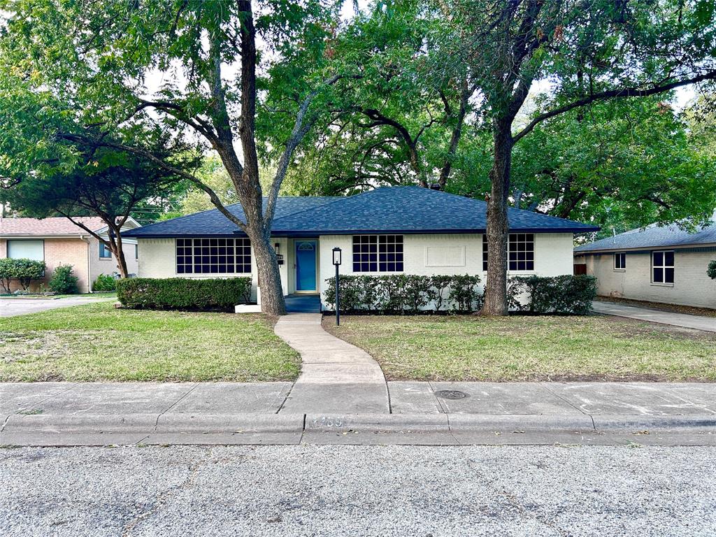 a front view of a house with a yard and porch