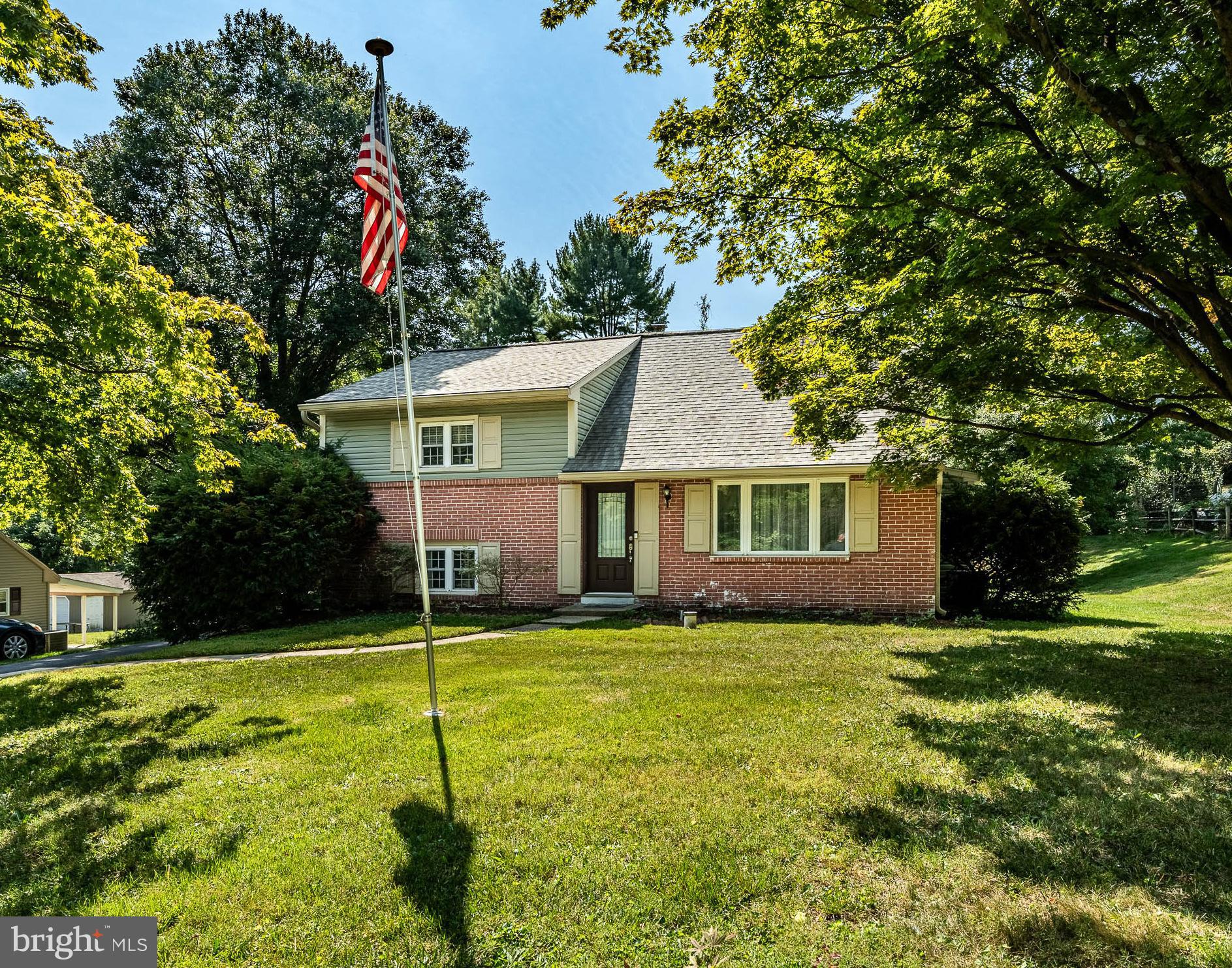 a view of a house with a yard and tree s